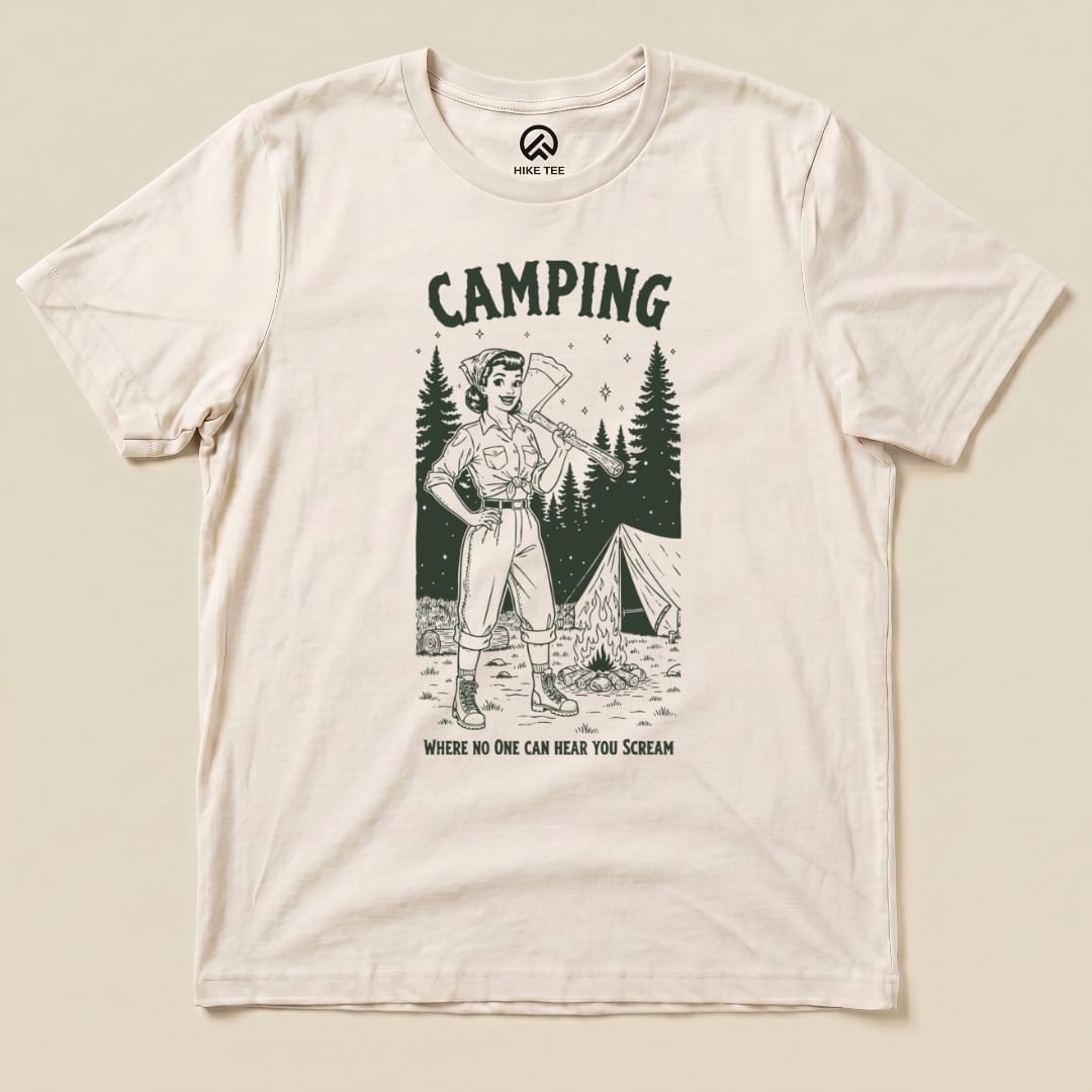 Graphic t-shirt featuring a confident camper with an axe, set against woods and a tent, with the phrase "Camping No One Can Hear You Scream.