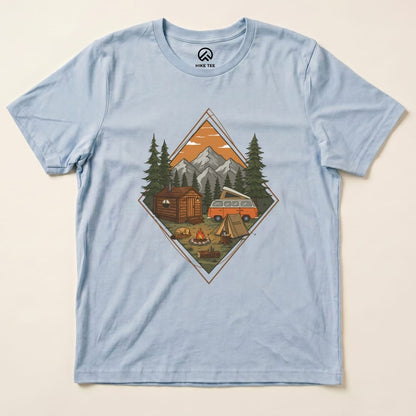 A graphic t-shirt featuring a cozy camping scene with a cabin, campfire, and vintage van under a mountain backdrop, labeled "Camping Scenery Shirt.
