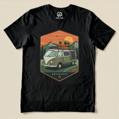 The graphic t-shirt features a vintage camping van with a kayak on top and mountain scenery, labeled "adventure" in an illustrated design.