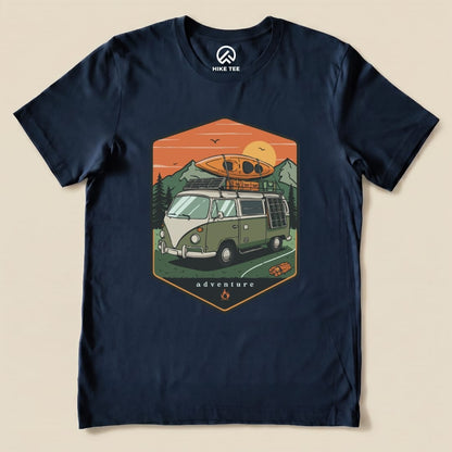 A navy graphic t-shirt featuring a vintage camping van with a kayak on top and the word "adventure" printed below.