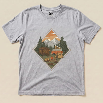 Graphic t-shirt featuring a camping scene with a vintage van, tent, campfire, and mountains, labeled "Camping Vibes Shirt.