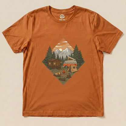 The Camping Vibes Shirt features a graphic of a cozy camping scene with a vintage van, tent, and campfire surrounded by trees and mountains.