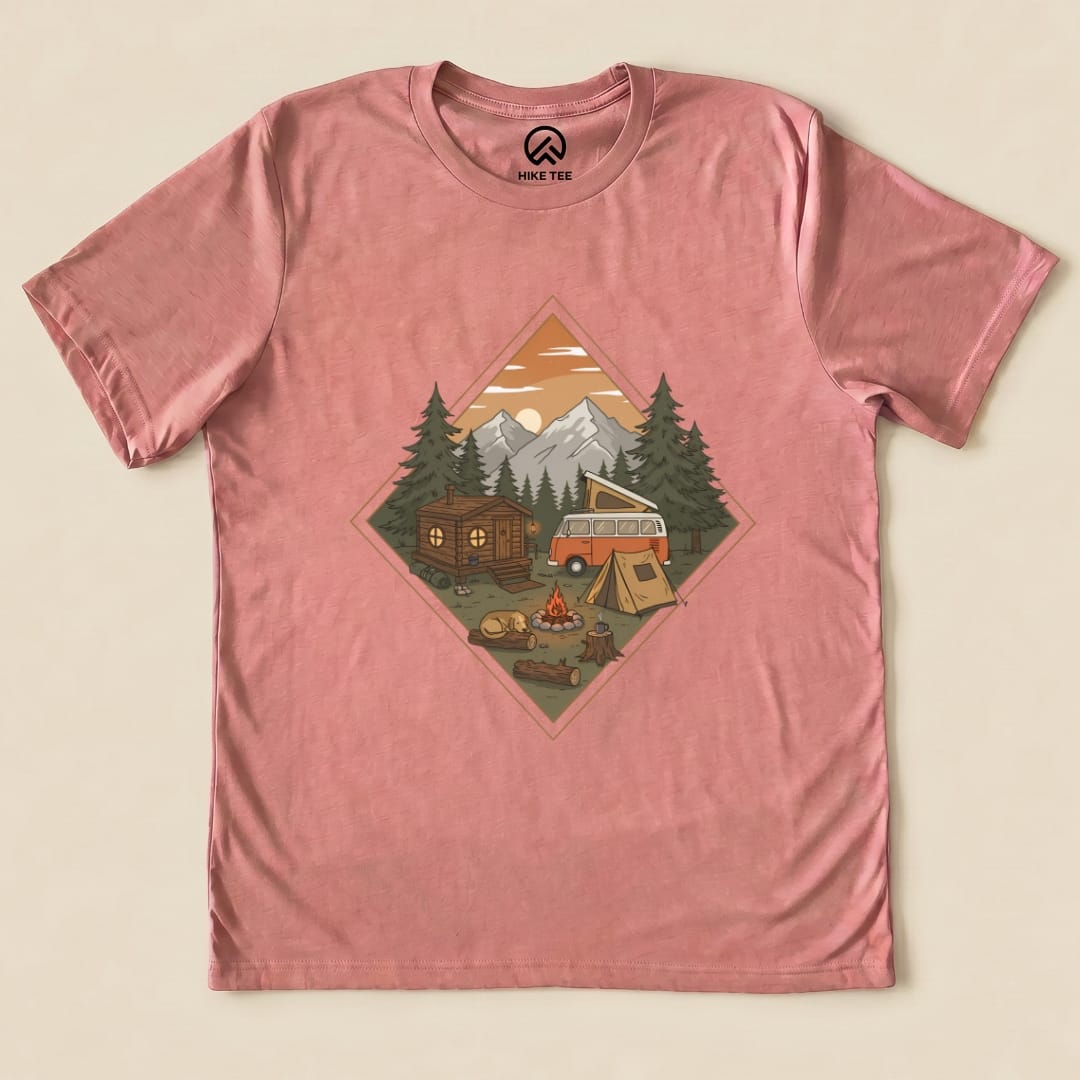The Camping Vibes Shirt features a vintage camper and cozy camp scene with trees, mountains, and a fire, all in a graphic design.