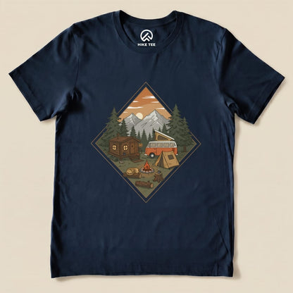 A graphic t-shirt featuring a camping scene with a vintage van, a cabin, tents, and a campfire, labeled "Camping Vibes Shirt.