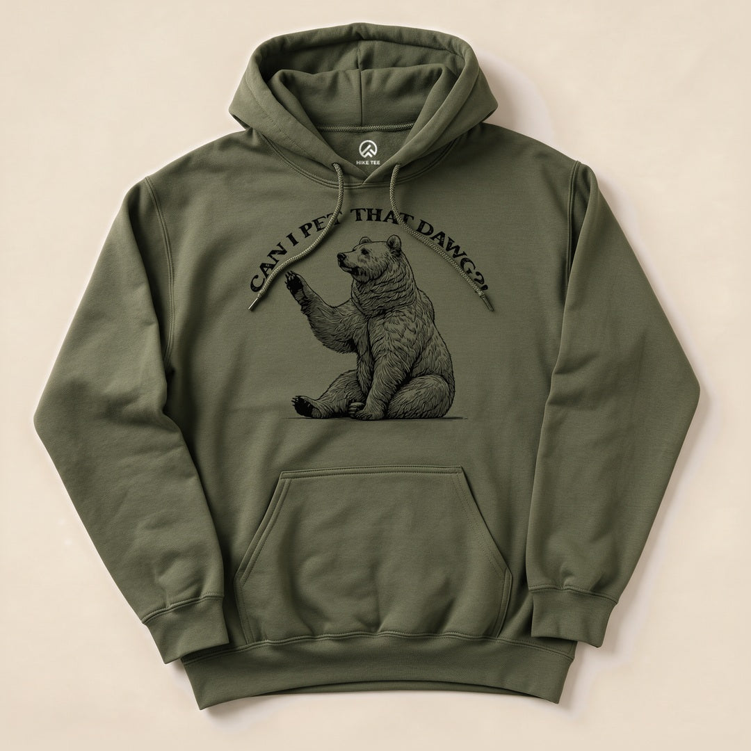 A green hoodie featuring a graphic of a sitting bear with the text "Can I Pet That Dawg?" above it, showcasing a funny outdoor theme.