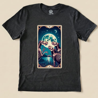 The graphic t-shirt features a colorful illustration of three skeletal capybaras under a full moon, titled "Capybara Moon Tarot Card Shirt.