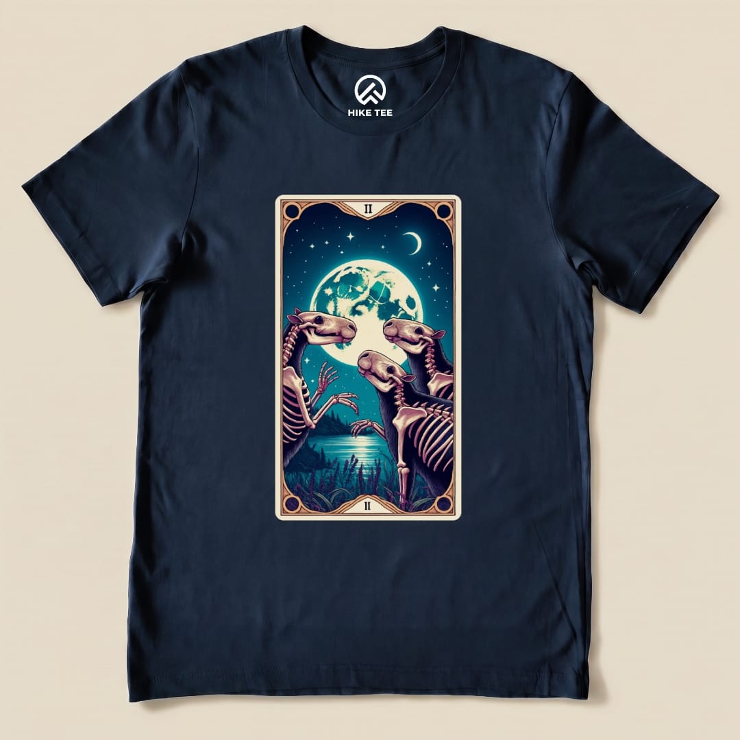 Graphic t-shirt featuring a whimsical "Capybara Moon Tarot Card Shirt" design with skeletal capybaras under a full moon.