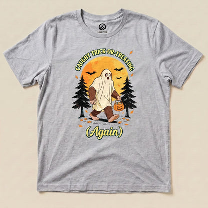 Athletic Heather Caught Trick-or-Treating Again Shirt with a Bigfoot in a ghost sheet trick-or-treating graphic