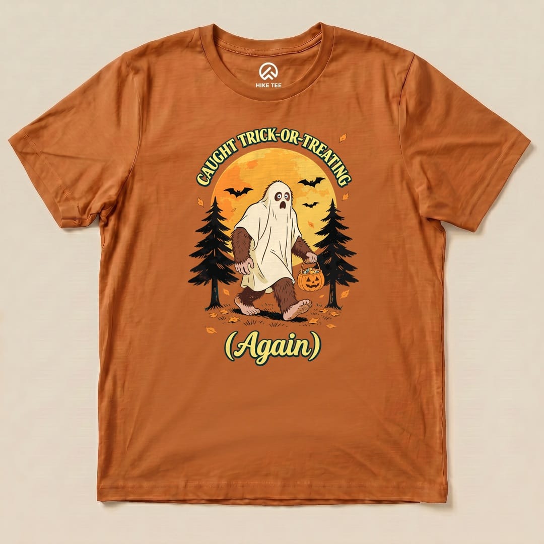 Autumn Caught Trick-or-Treating Again Shirt with a Bigfoot in a ghost sheet trick-or-treating graphic