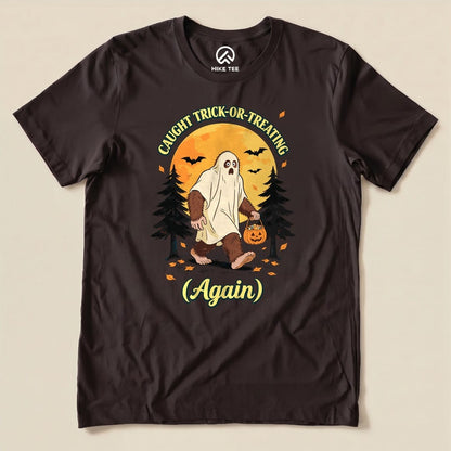 Brown Caught Trick-or-Treating Again Shirt with a Bigfoot in a ghost sheet trick-or-treating graphic