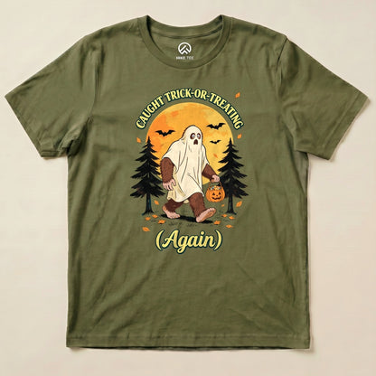 Military Green Caught Trick-or-Treating Again Shirt with a Bigfoot in a ghost sheet trick-or-treating graphic