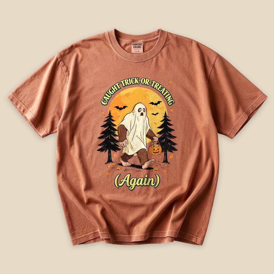 Yam Caught Trick-or-Treating Again T-Shirt with a Bigfoot in a ghost sheet trick-or-treating graphic