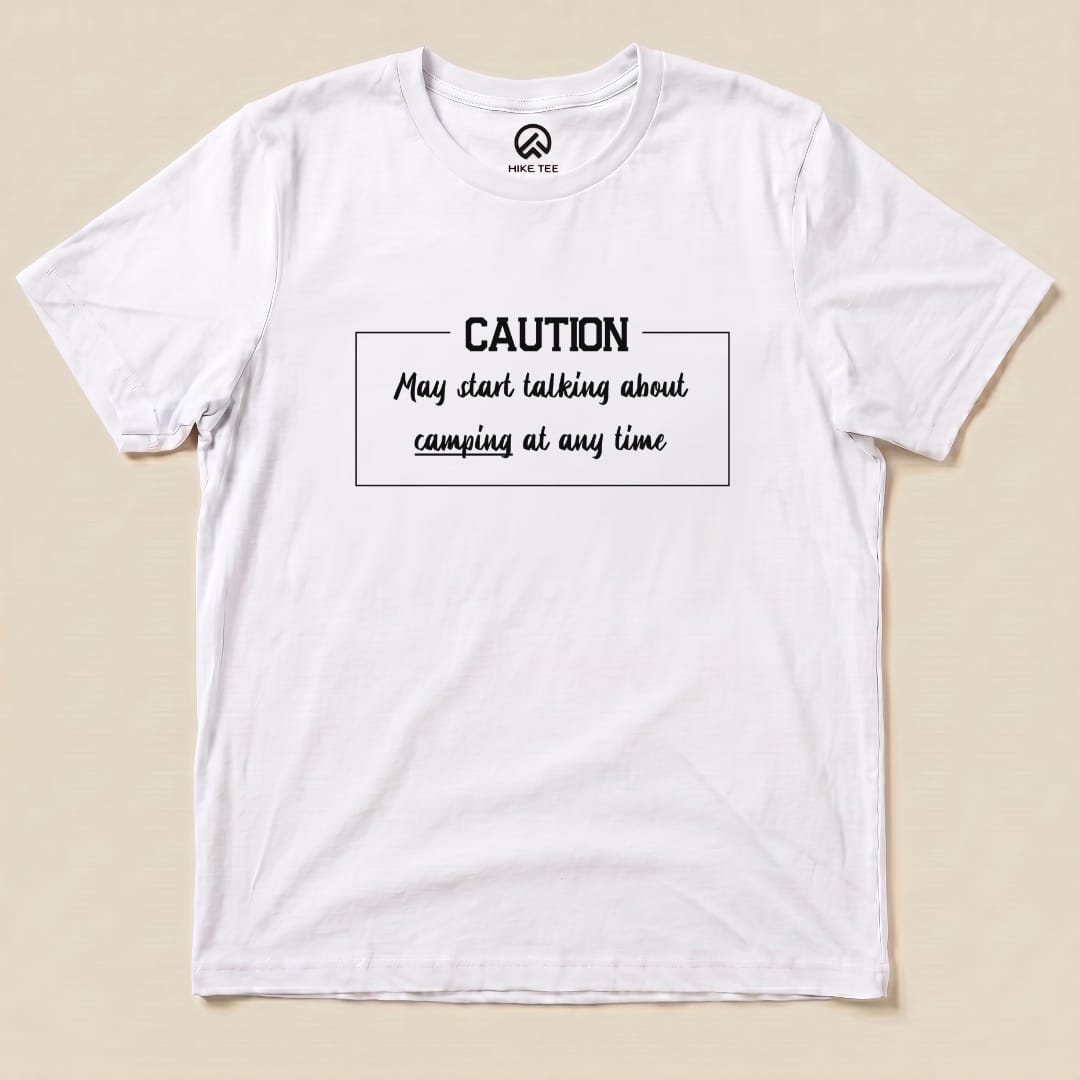 Graphic t-shirt featuring the slogan "Caution May start talking about camping at any time" printed on a white background.