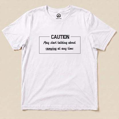 Graphic t-shirt featuring the slogan "Caution May start talking about camping at any time" printed on a white background.