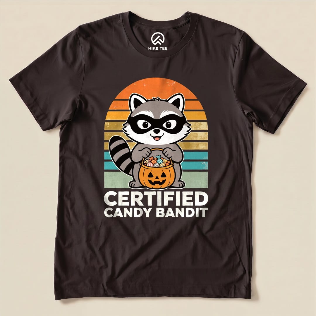 Brown Certified Candy Bandit Shirt with a masked raccoon holding a pumpkin candy bucket graphic