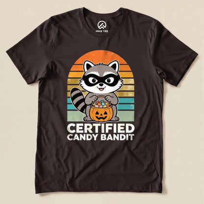 Brown Certified Candy Bandit Shirt with a masked raccoon holding a pumpkin candy bucket graphic