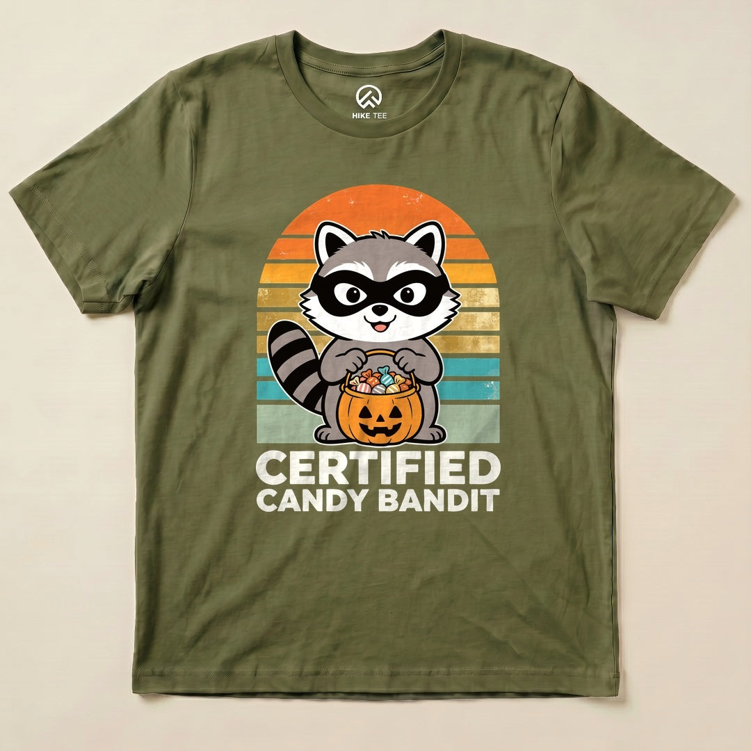 Military Green Certified Candy Bandit Shirt with a masked raccoon holding a pumpkin candy bucket graphic
