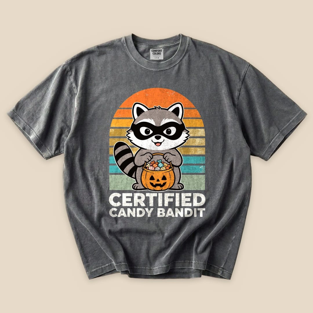 The graphic t-shirt features a raccoon holding a pumpkin filled with candy, accompanied by the text "Certified Candy Bandit.