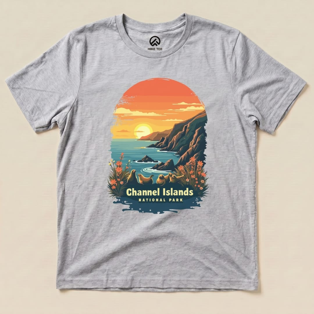 A graphic t-shirt featuring a sunset over coastal cliffs and the text "Channel Islands National Park" with floral accents.