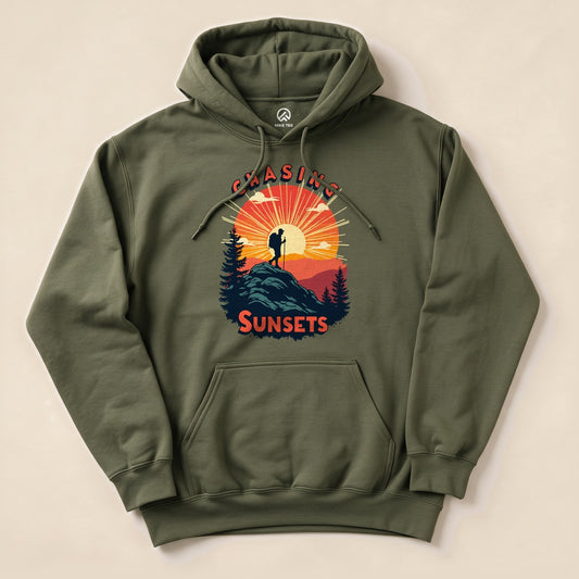 The Chasing Sunsets Hoodie is an olive green graphic sweatshirt featuring a silhouette of a hiker against a sunset backdrop.