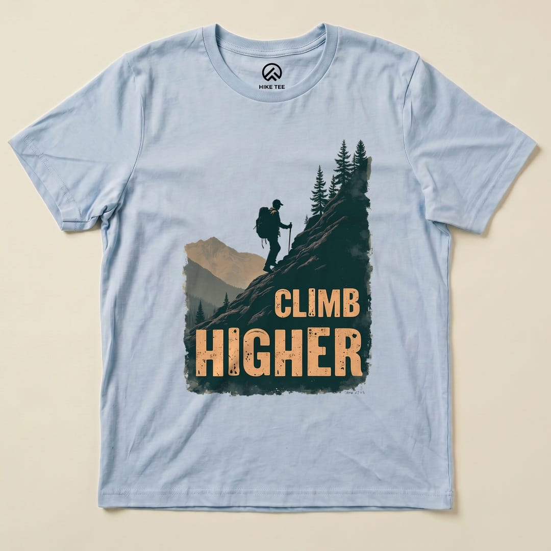 Baby Blue Climb Higher Shirt with a hiker climbing a mountain graphic