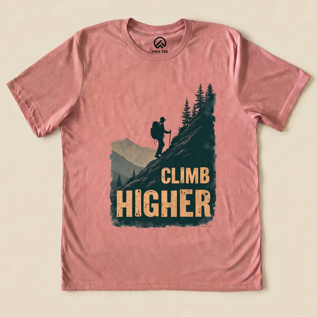 Heather Mauve Climb Higher Shirt with a hiker climbing a mountain graphic