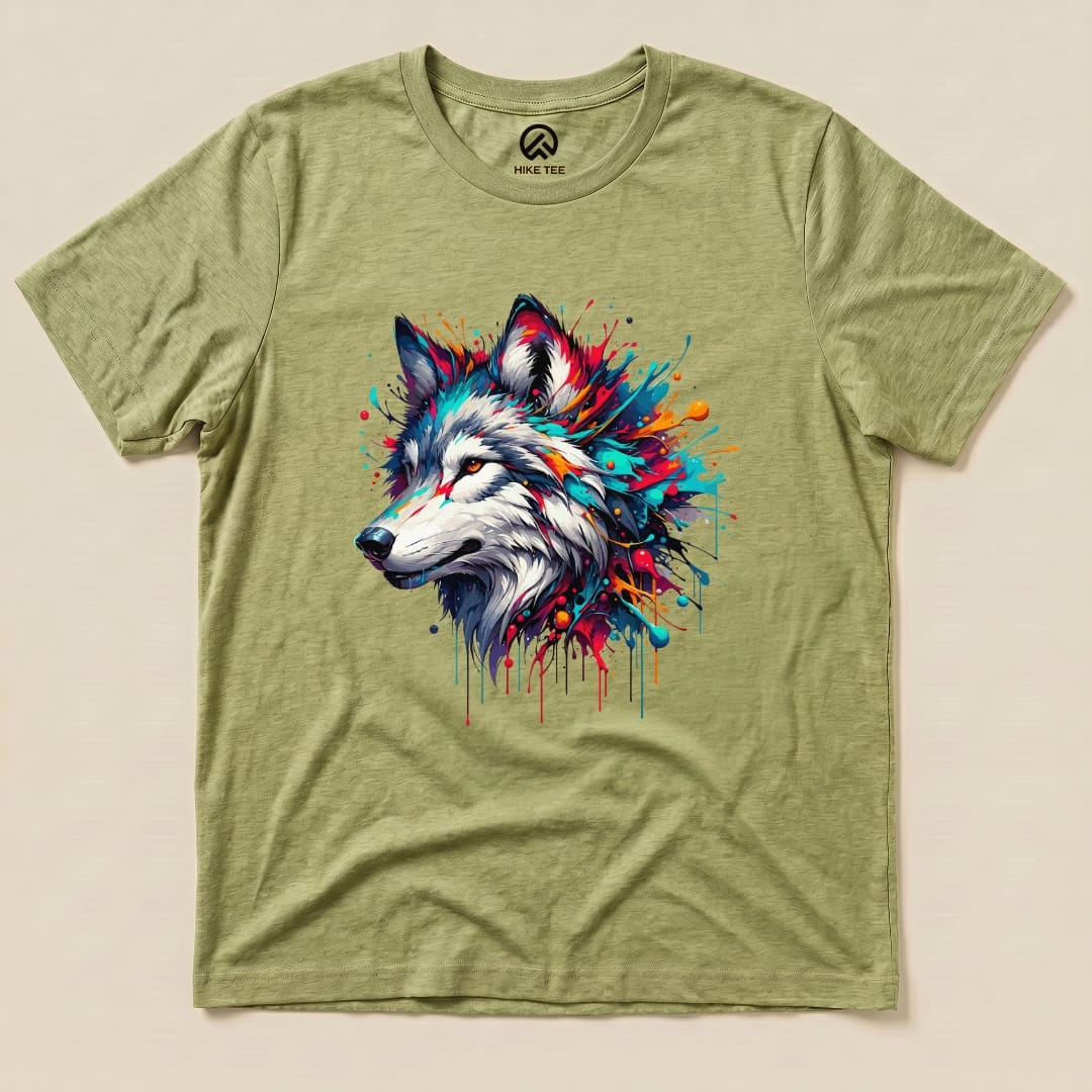 A graphic t-shirt featuring a colorful wolf design with vibrant splashes of paint on an olive green background.
