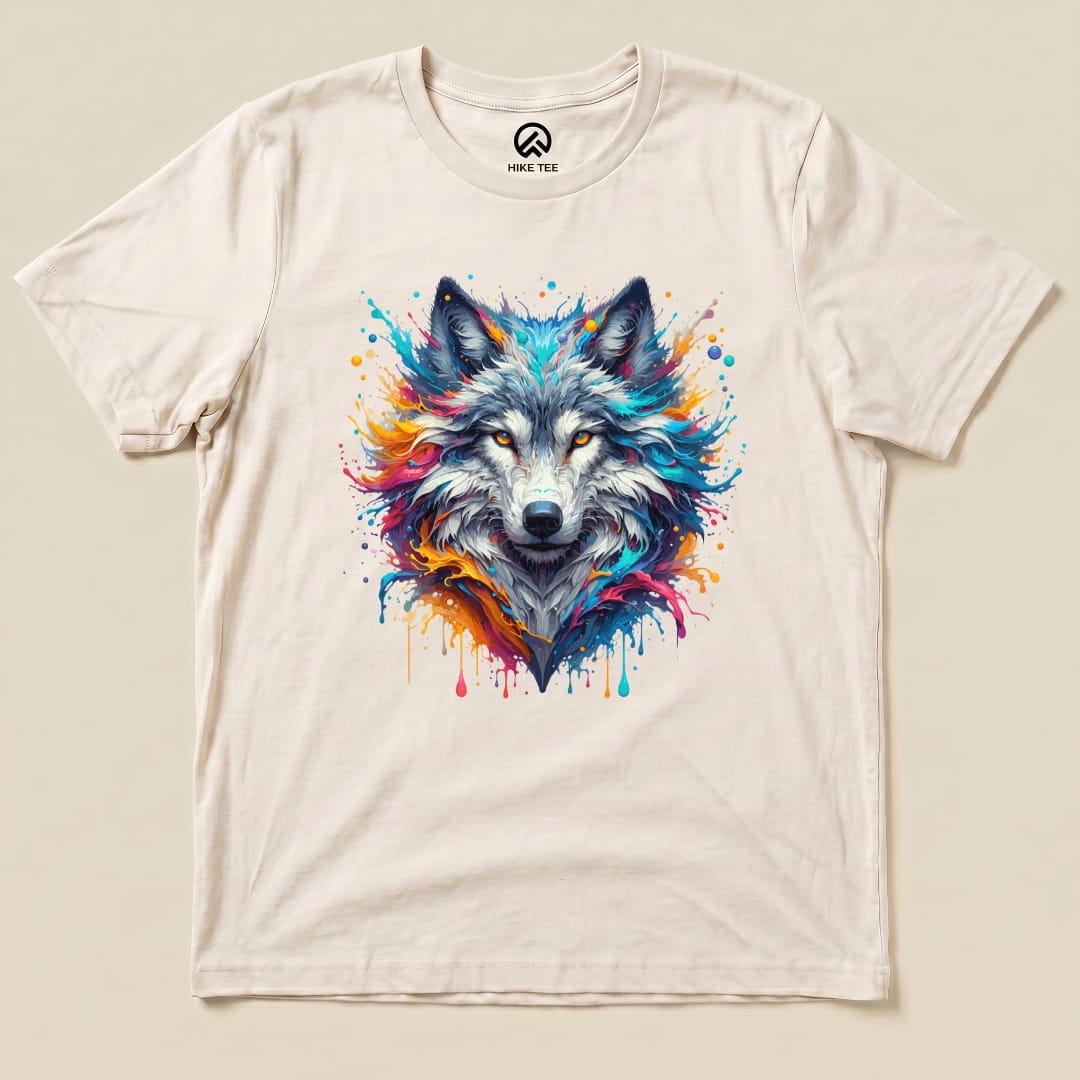 A colorful wolf shirt featuring a vibrant graphic of a wolf's head surrounded by splashes of paint on a light background.