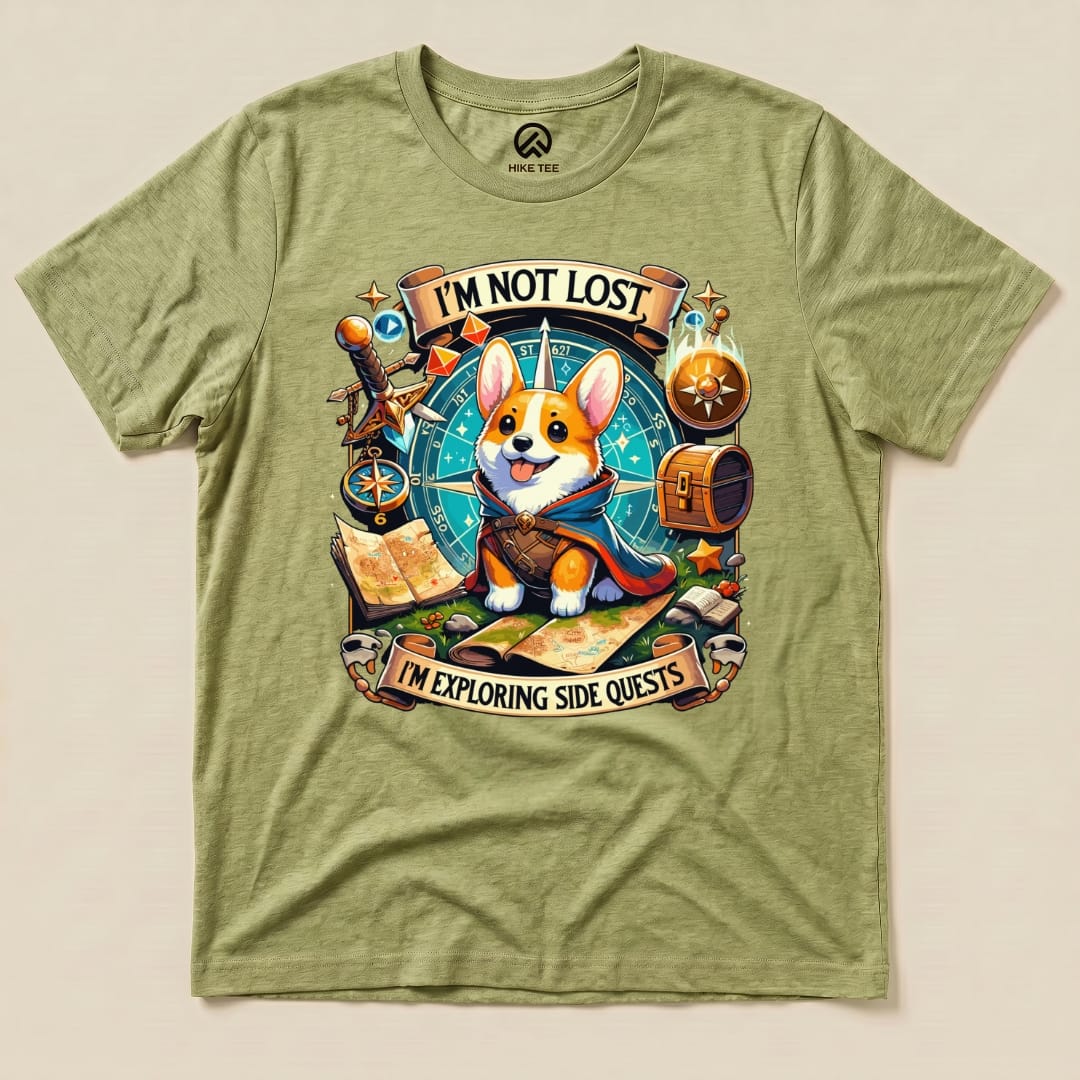 The Corgi I'm Not Lost Shirt features a playful graphic of a corgi wearing a cape, surrounded by maps and adventure-themed elements.