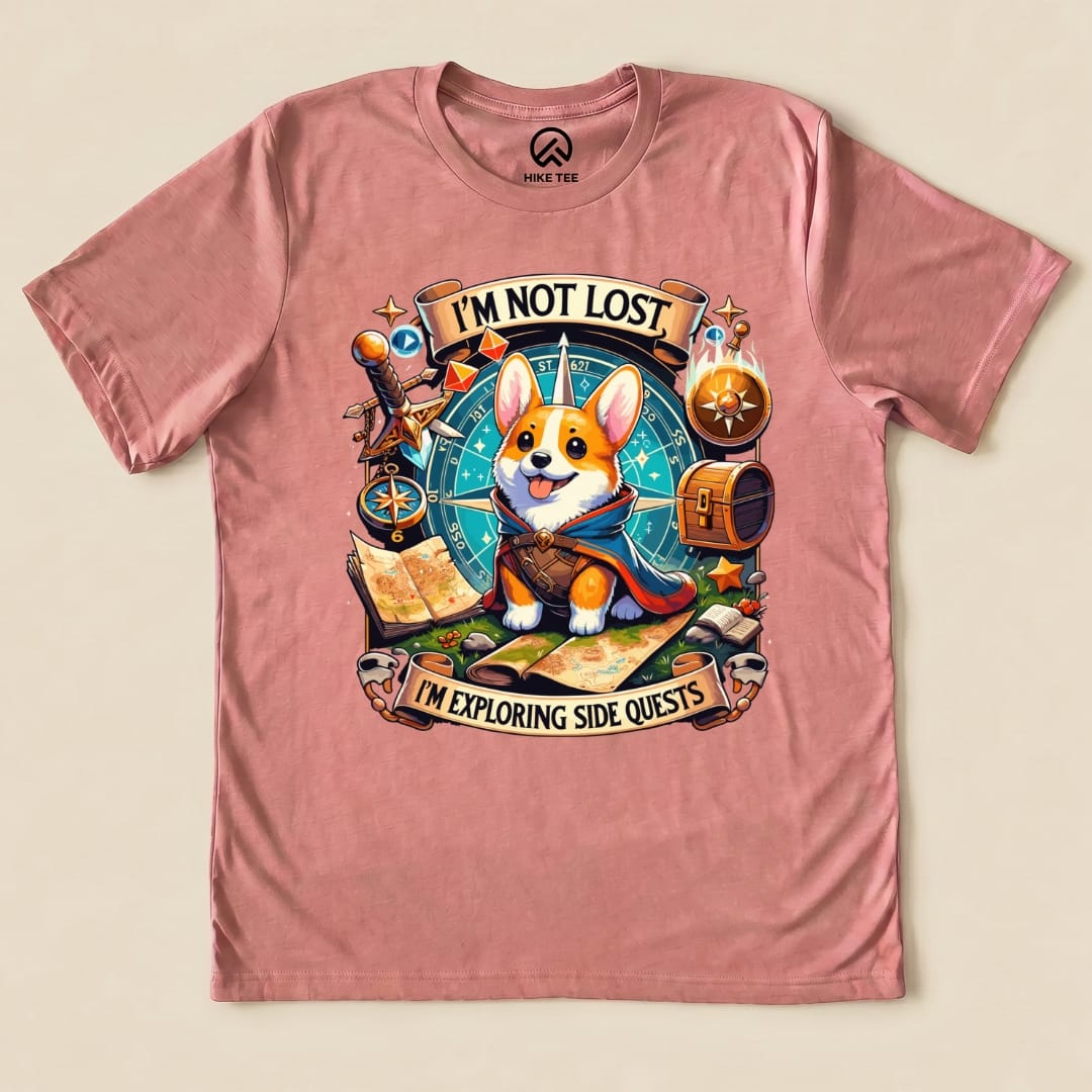 A graphic t-shirt featuring a cute corgi surrounded by maps, a compass, and the text "I'm Not Lost, I'm Exploring Side Quests".