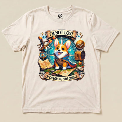 The graphic t-shirt features a playful corgi in a cape surrounded by a compass, maps, and the slogan "I'm Not Lost, I'm Exploring Side Quests.
