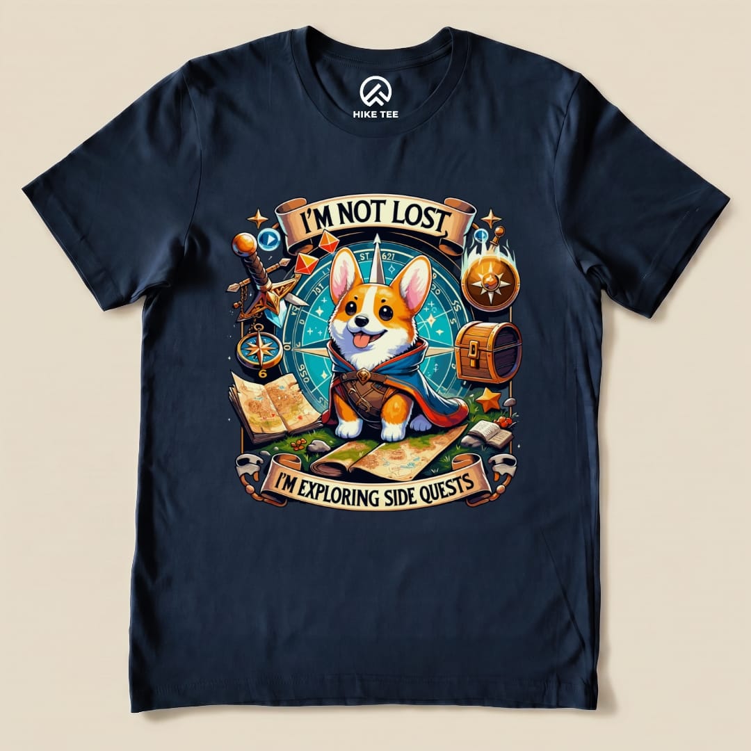 A navy graphic t-shirt features a playful corgi in a cape, with the text "I'M NOT LOST, I'M EXPLORING SIDE QUESTS" above.