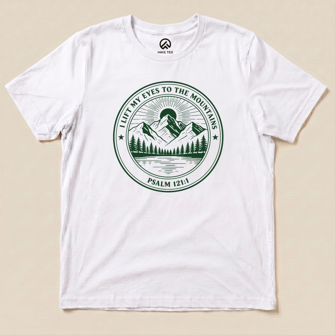 White I Lift My Eyes to the Mountains Shirt with a mountain lake badge with Psalm 121:1 graphic
