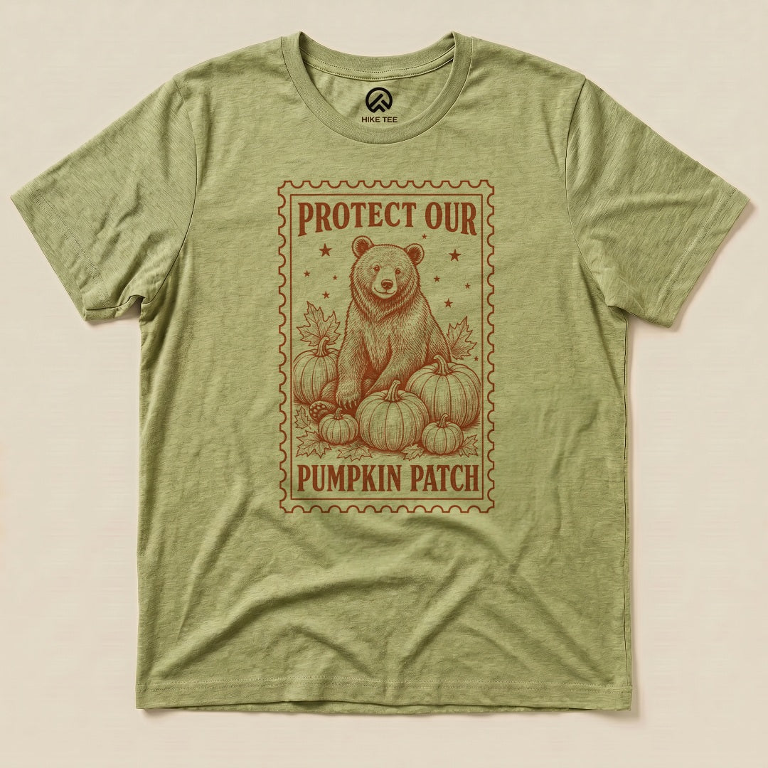 Heather Green Protect Our Pumpkin Patch Shirt with a bear among pumpkins in a vintage stamp frame graphic