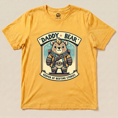 A yellow graphic t-shirt features a cartoon bear dressed as a rugged adventurer with the words "Daddy Bear" and "Keeper of Bedtime Stories.