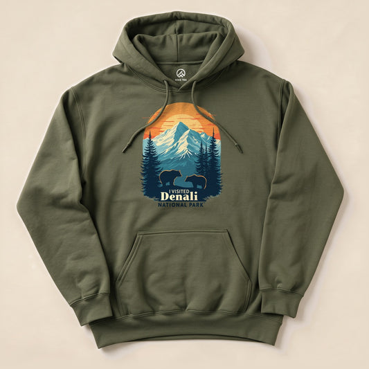 A graphic olive green "Denali National Park Hoodie" featuring a mountain scene with two bears and the text "I Visited Denali National Park.
