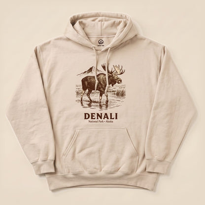Denali National Park Moose Hoodie features a moose standing by water with mountains in the background and "DENALI National Park • Alaska" printed below.