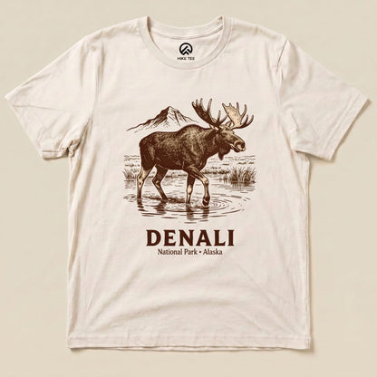 Graphic t-shirt featuring a moose standing in water with mountains in the background, labeled "Denali National Park Moose Shirt.