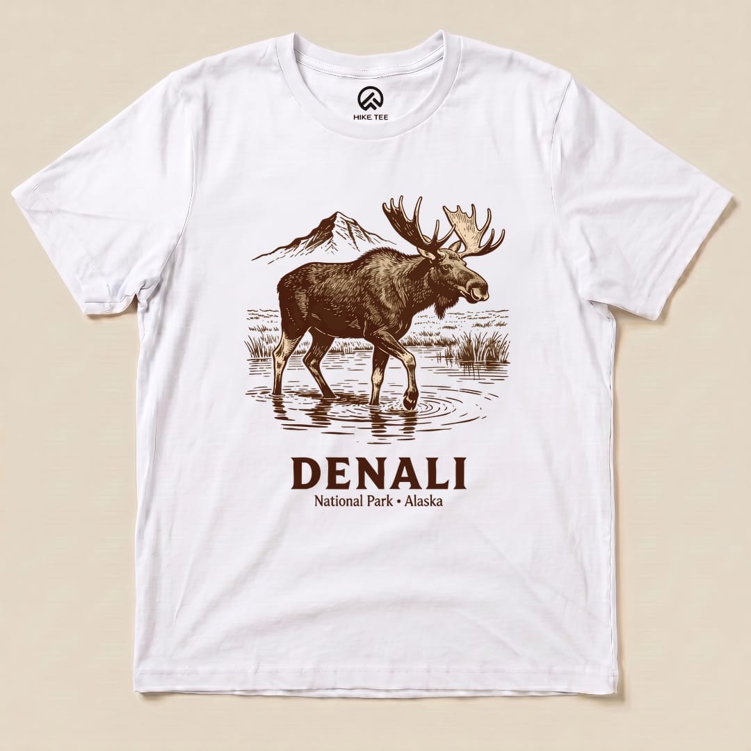 A graphic t-shirt featuring a moose standing in water with the text "DENALI National Park • Alaska" beneath it.