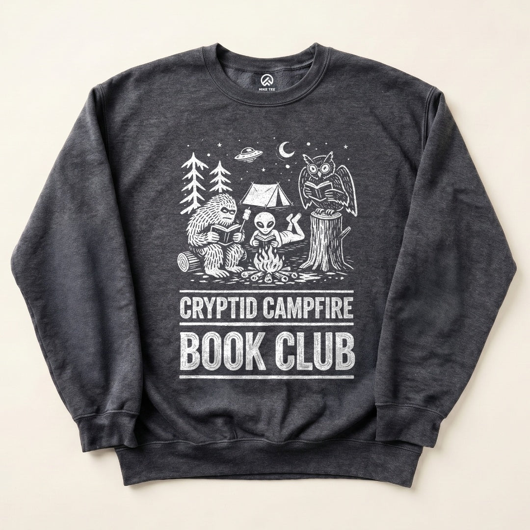 Dark Heather Cryptid Campfire Book Club Sweatshirt with a Bigfoot and friends reading around a campfire graphic