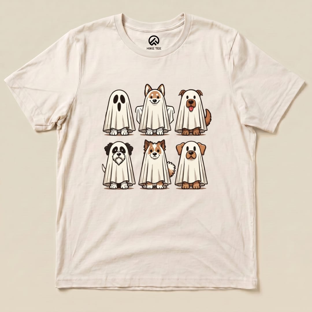 The Dog Ghosts Shirt features six cartoon dogs playfully dressed as ghosts, printed on a light-colored graphic t-shirt.