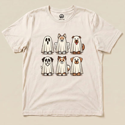 The Dog Ghosts Shirt features six cartoon dogs playfully dressed as ghosts, printed on a light-colored graphic t-shirt.