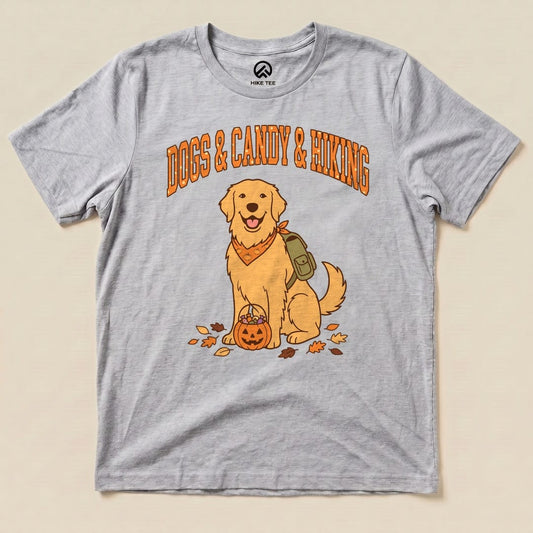 A graphic t-shirt featuring a cheerful golden retriever with a pumpkin basket and the words "Dogs & Candy & Hiking" above.