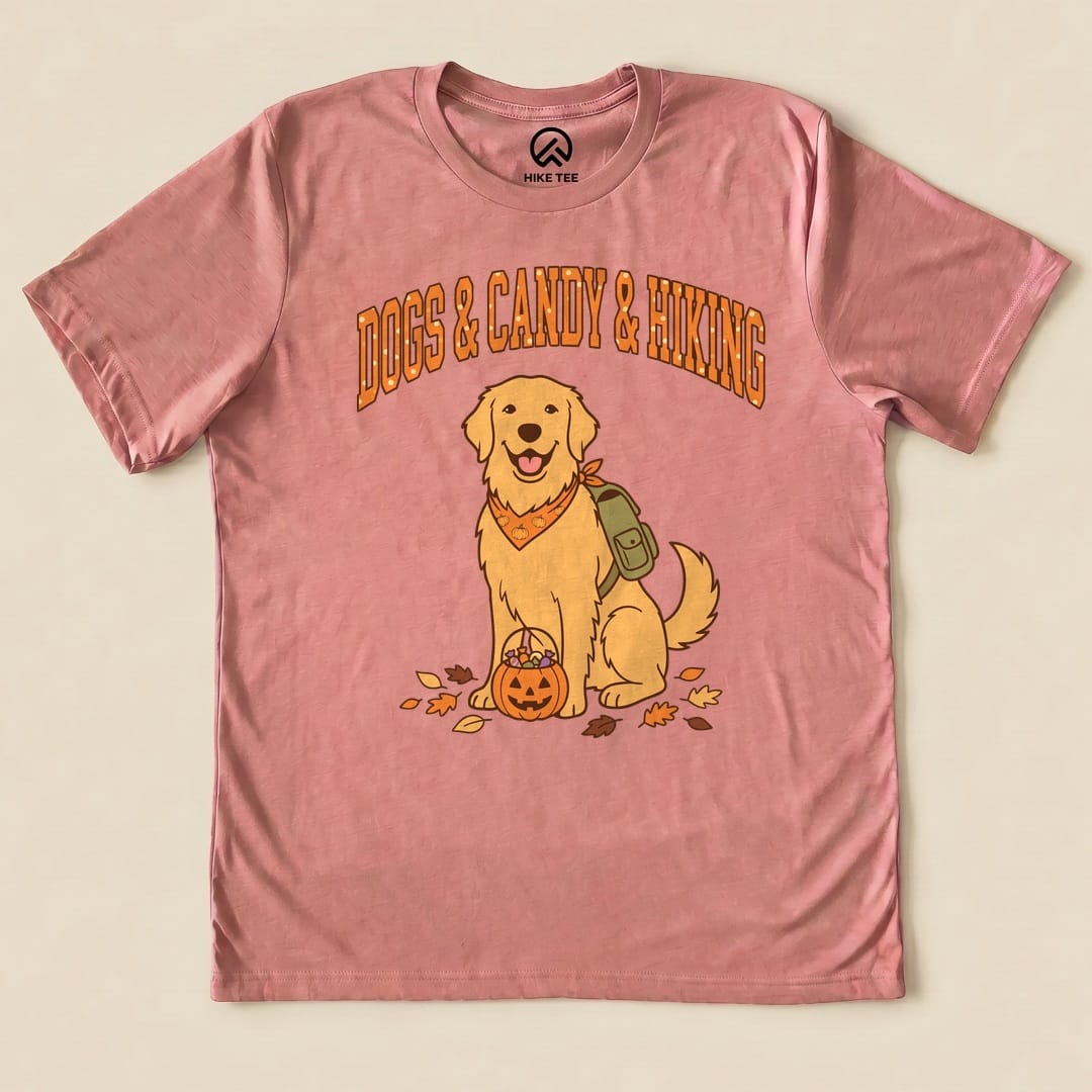 The graphic t-shirt features a cheerful golden retriever with a backpack and a pumpkin, surrounded by autumn leaves, captioned "Dogs & Candy & Hiking Shirt.