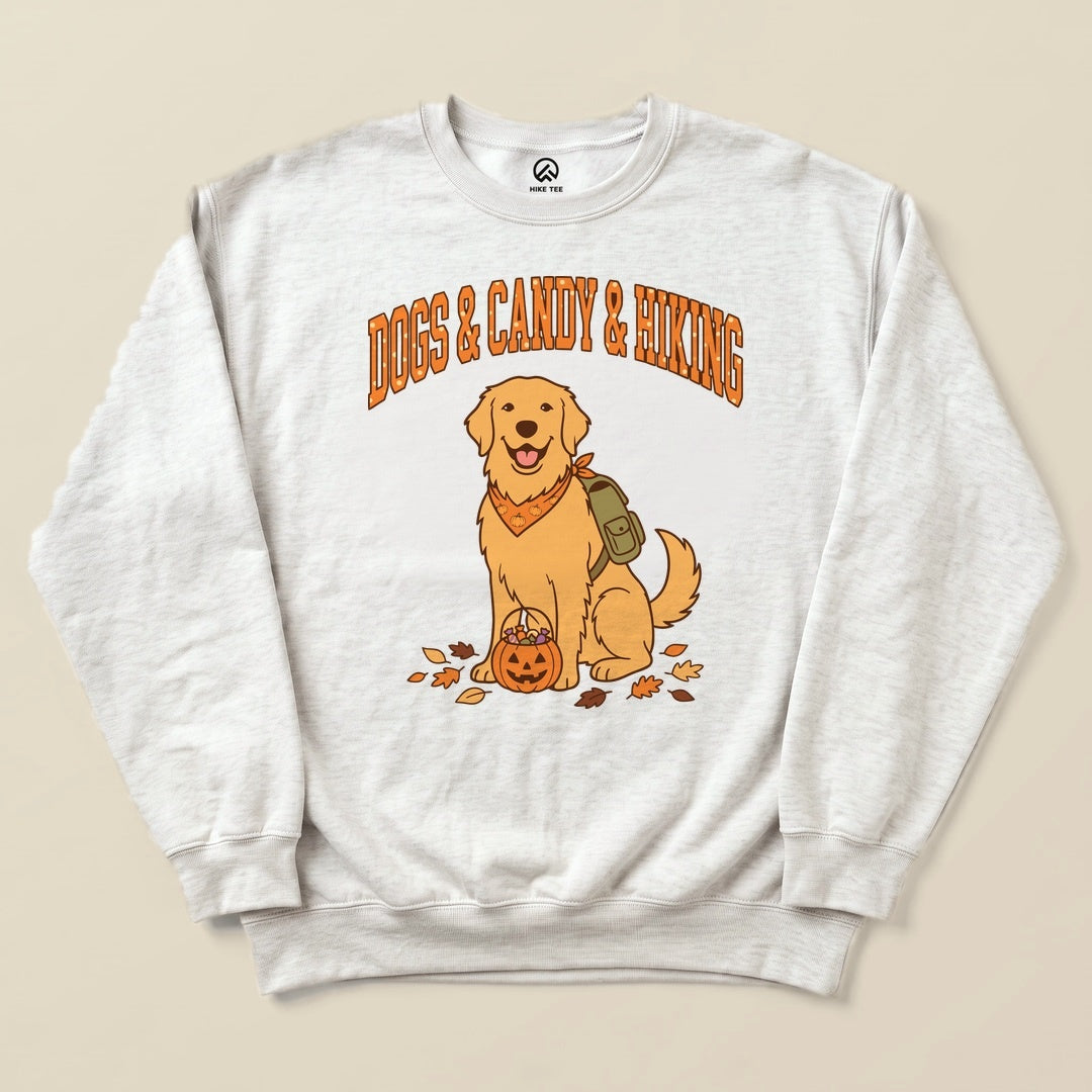 A graphic sweatshirt featuring a happy golden retriever with a backpack and a pumpkin, labeled "Dogs & Candy & Hiking.