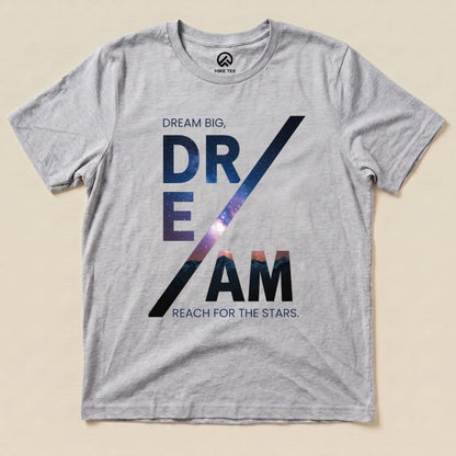 A graphic t-shirt featuring the words "Dream Big, DREAM" with a cosmic design, alongside "Reach for the Stars," labeled as a Dream Motivational Shirt.