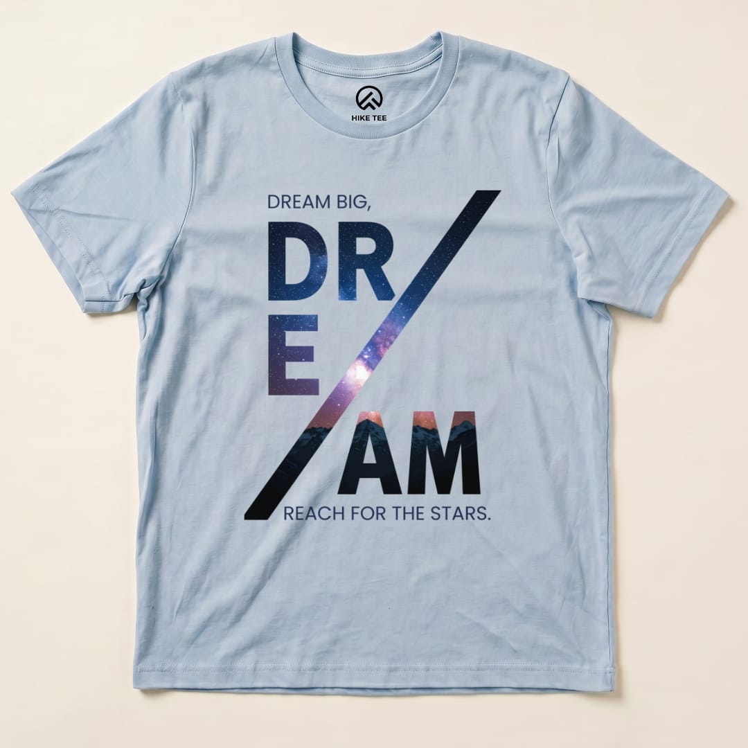 A light blue graphic t-shirt featuring the words "Dream Big, DREAM / Reach for the Stars" with a cosmic background.