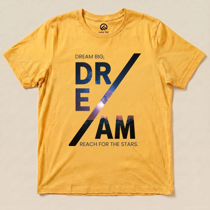 A flat lay of a yellow graphic t-shirt featuring the words "DREAM BIG, DREAM REACH FOR THE STARS" in bold, starry letters, labeled as "Dream Motivational Shirt.