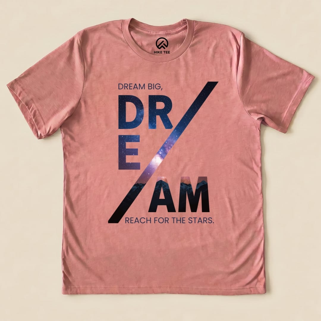 A pink graphic t-shirt features the slogan "DREAM BIG, DREAM REACH FOR THE STARS," showcasing the Dream Motivational Shirt design.
