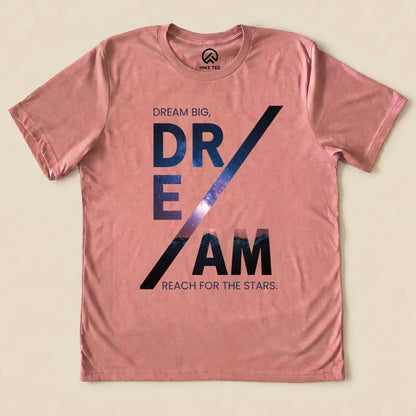 A pink graphic t-shirt features the slogan "DREAM BIG, DREAM REACH FOR THE STARS," showcasing the Dream Motivational Shirt design.